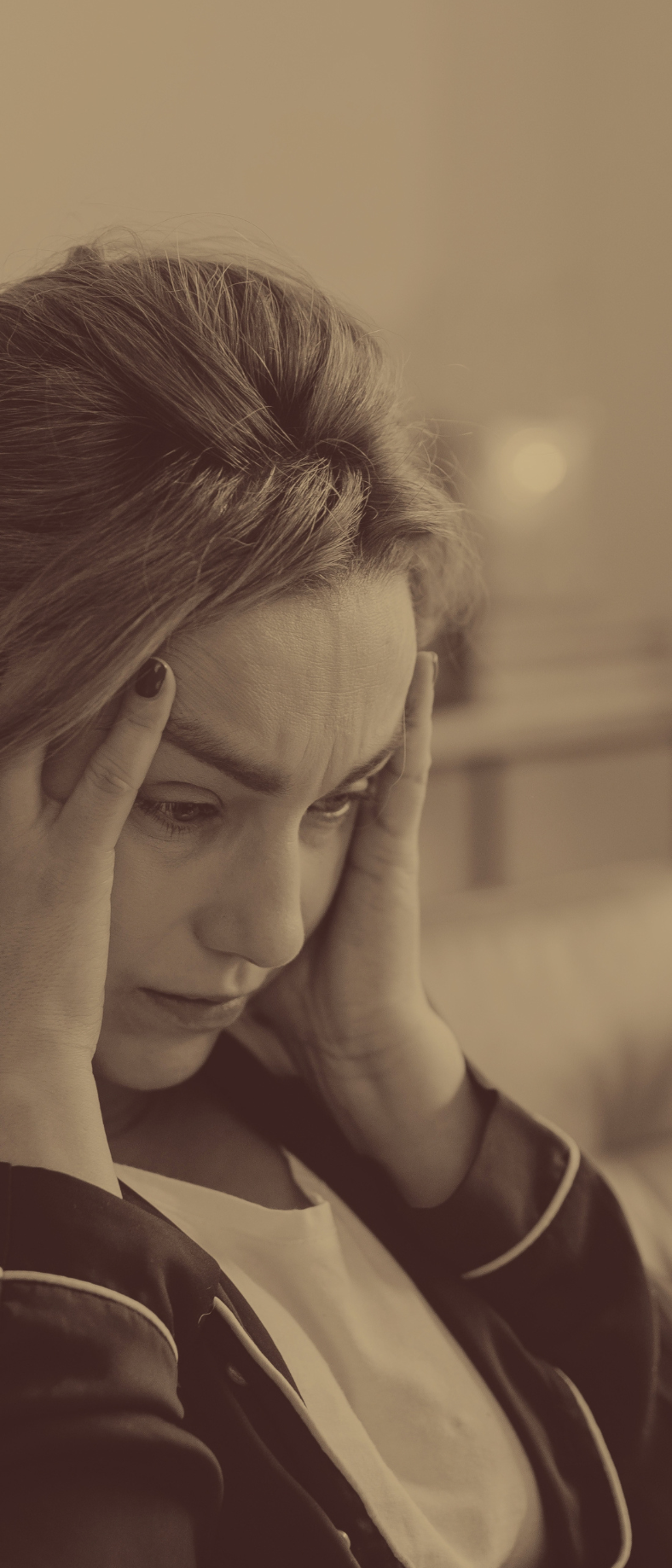 woman with headache, holding her head