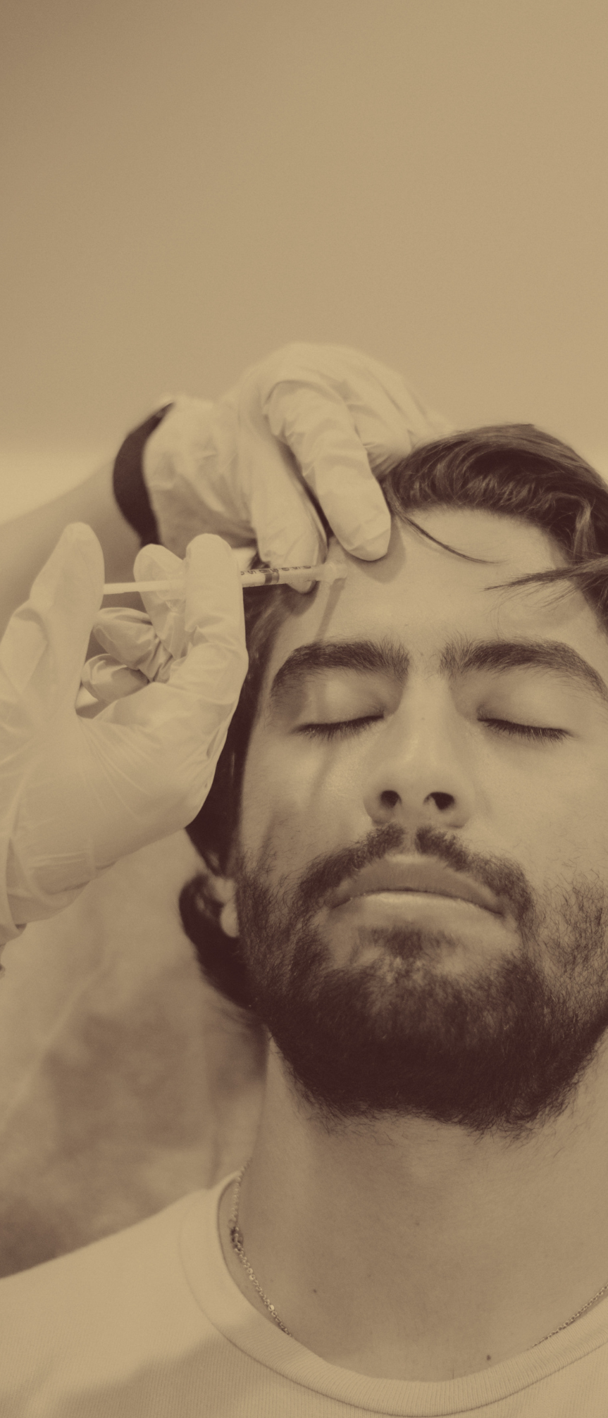 man receiving botox in his forehead