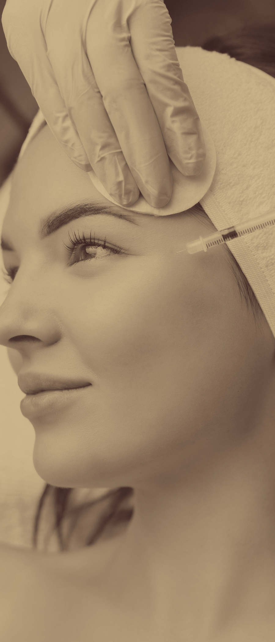 woman getting botox near her eyes/ crows feet